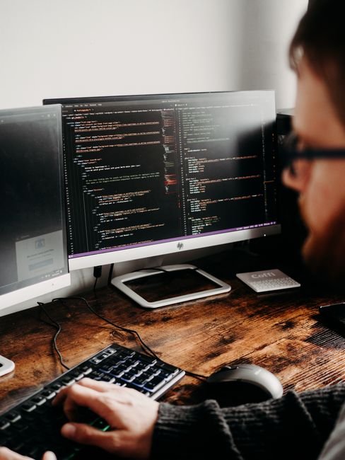 Developer working on code optimization tools and scripts to enhance website speed.