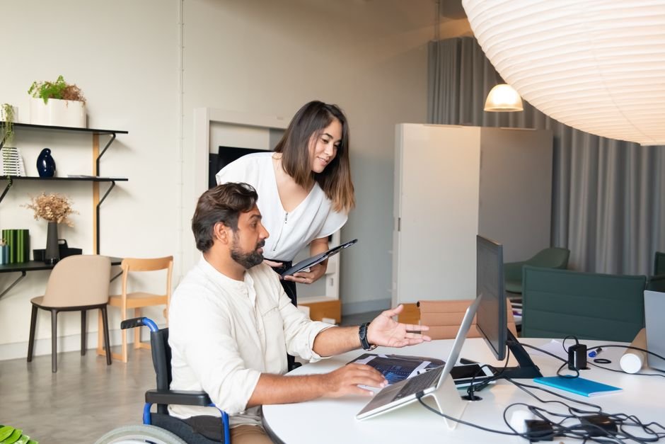 A team collaboratively conducting an accessibility audit with various digital tools and software.