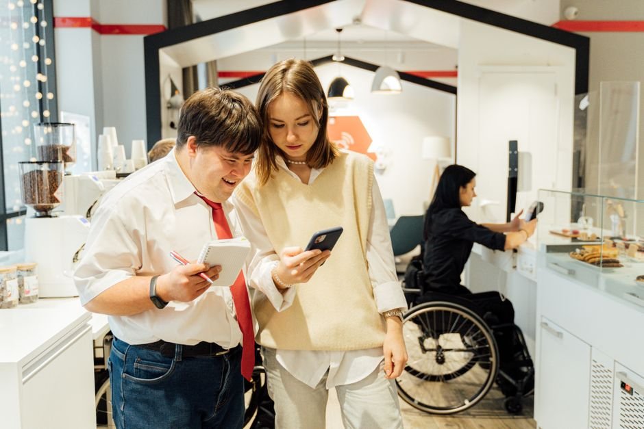 Diverse users interacting with accessible technology, showcasing seamless digital engagement.