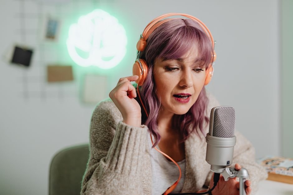A person intently listening to a podcast through headphones, demonstrating audience engagement