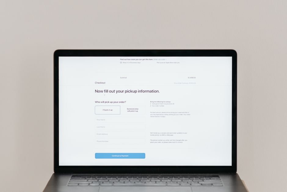 Person completing an online purchase on a laptop, emphasizing Shopify checkout conversion.