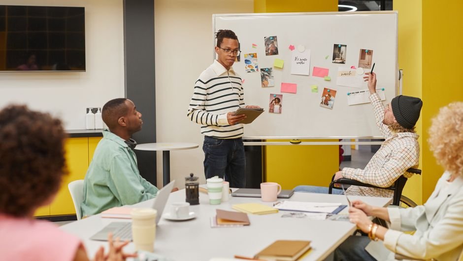 Designers collaborating on inclusive product development strategy in a modern office.