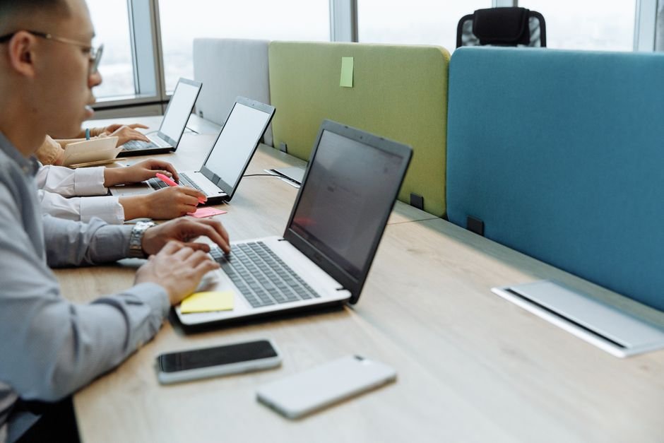 Professional team working on productivity optimization using enterprise workflow strategies in a modern office.