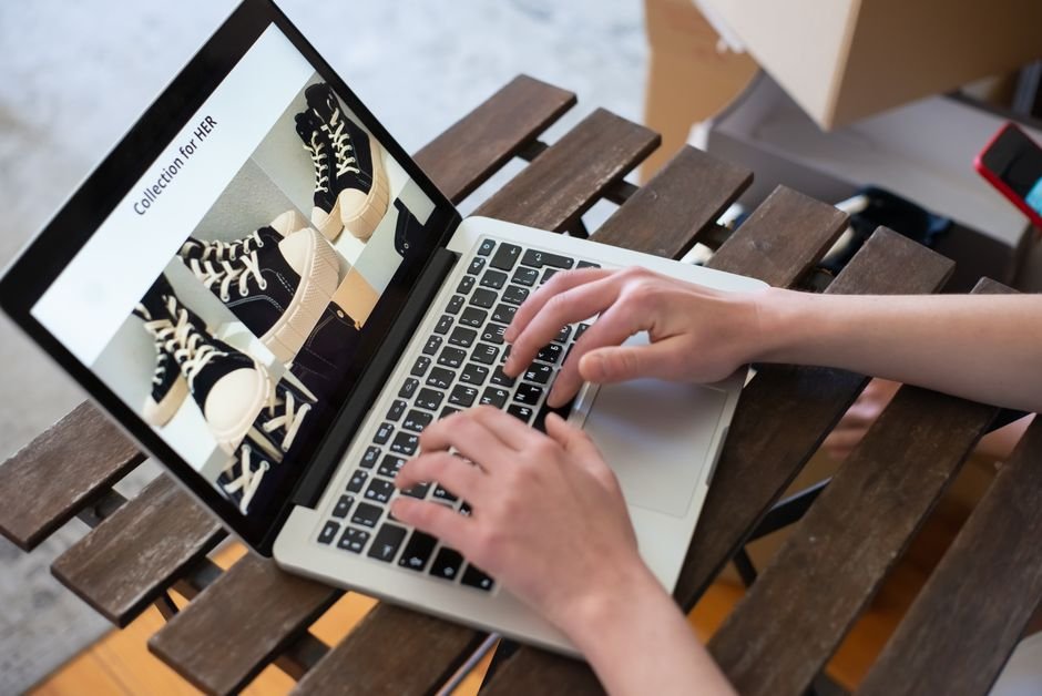 Person using a laptop for visual search, browsing e-commerce items online.