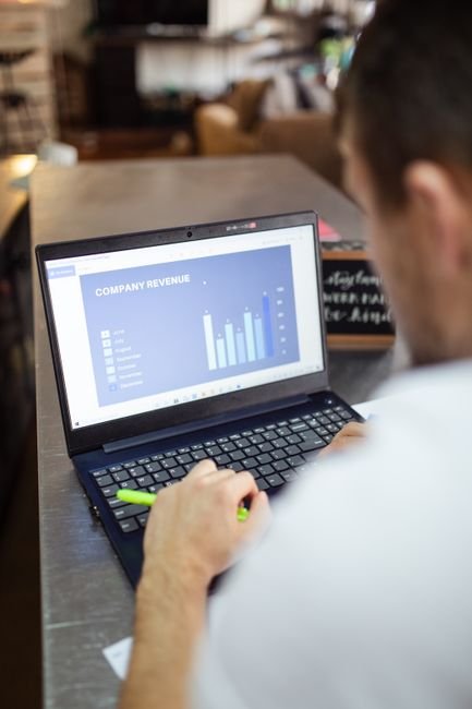 Small business owner analyzing reports, improving SMB automation with digital tools.