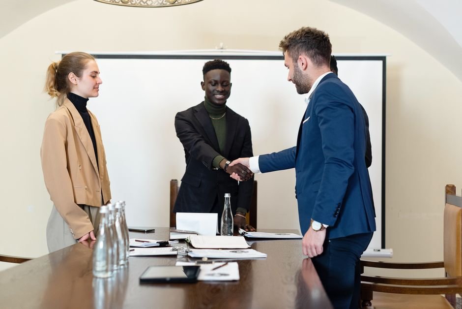 Corporate partners shaking hands to seal a high-value enterprise workflow deal.